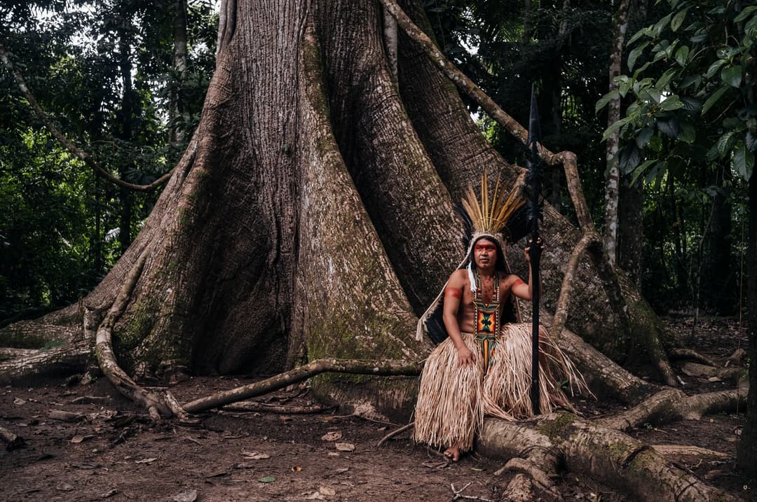 A traditional learning circle on open land with participants engaged in hands-on earth practice