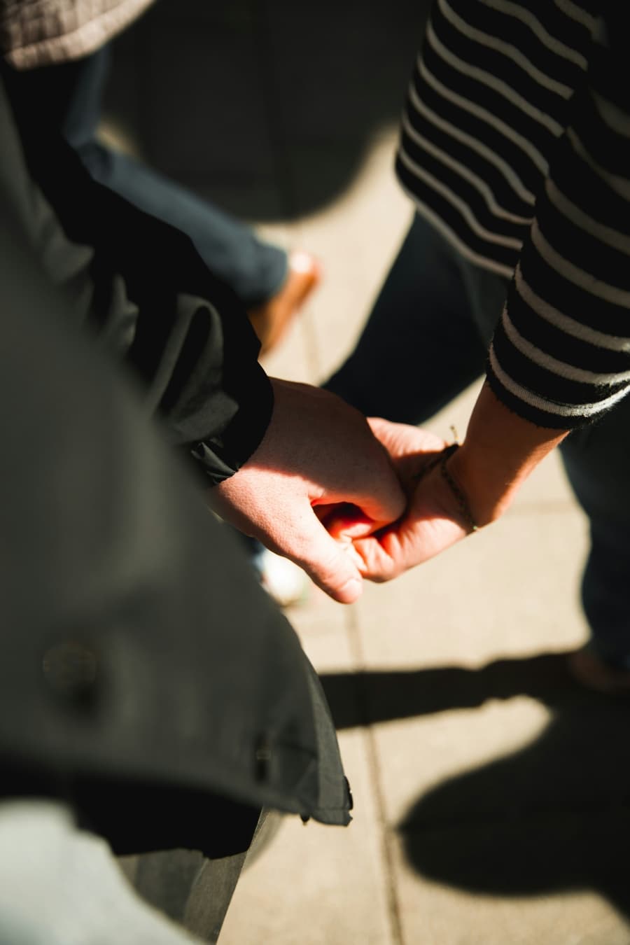 Hands touching rich dark soil on the farm